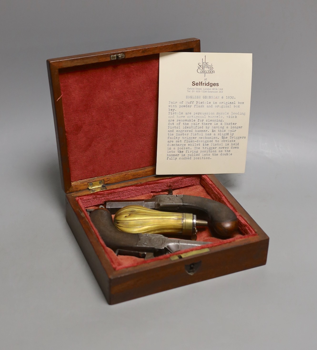 A pair of muff pistols and powder flask, original fitted mahogany case and key, circa 1830